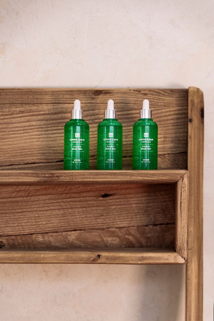 Three bottles on wooden shelf